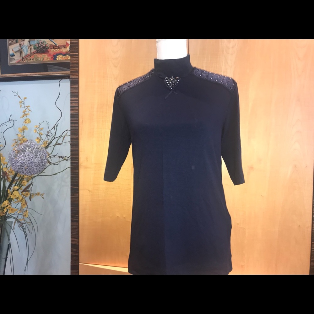 A designer turtleneck top with stones